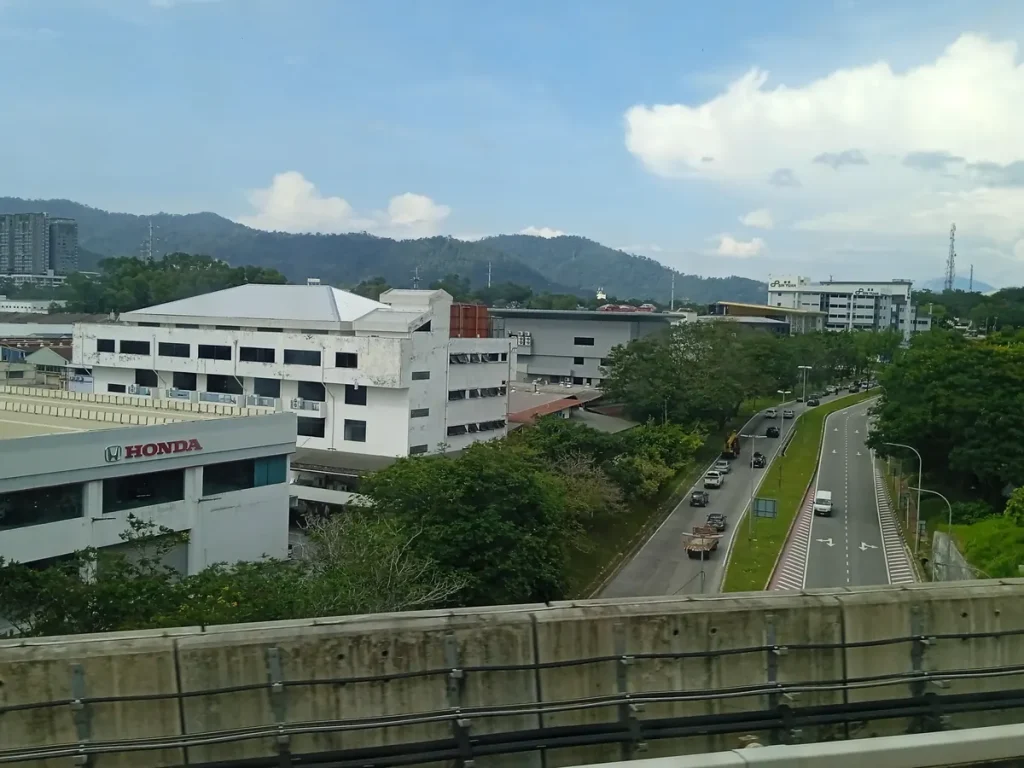 Roads, commercial buildings and wooded hills in Bandar Sri Damansara