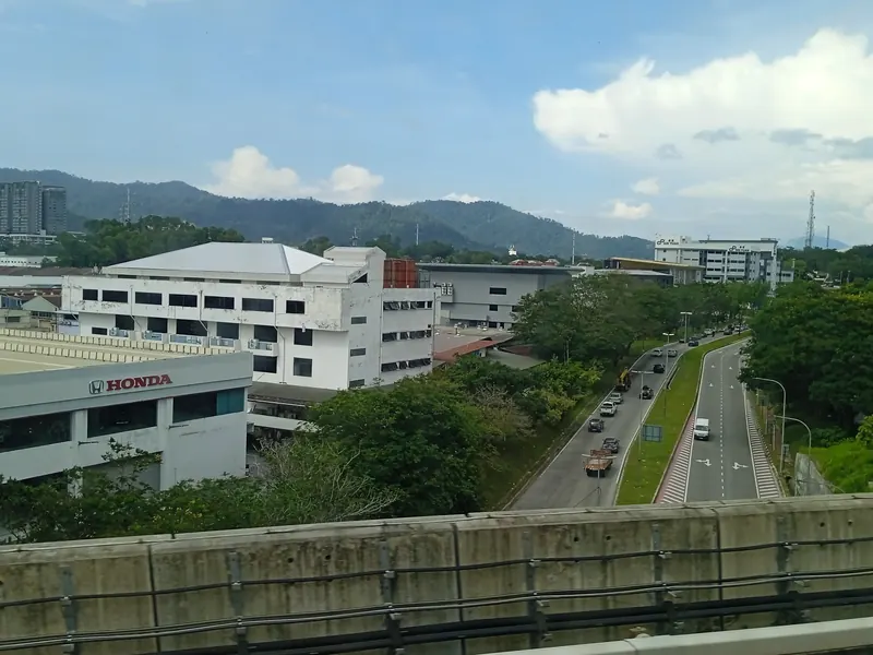 Roads, commercial buildings and wooded hills in Bandar Sri Damansara