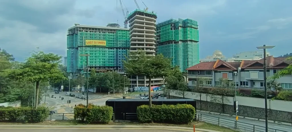 Road junction and residential buildings seen from Publika, including a tower under construction