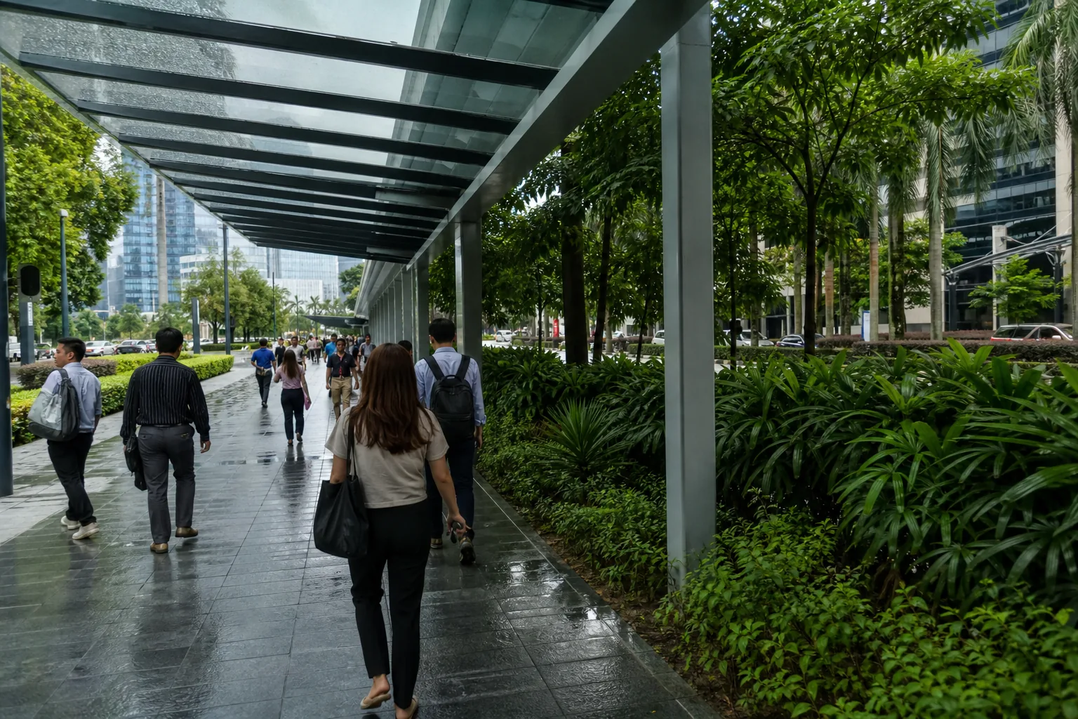 Residents and office workers using a covered pedestrian walkway in central Kuala Lumpur after rain