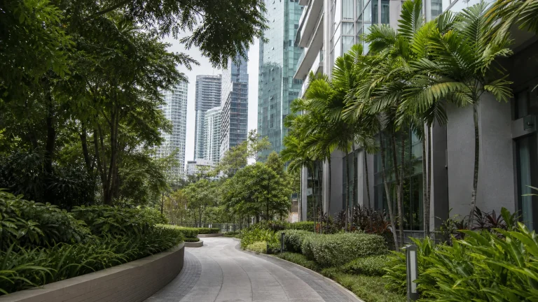 Landscaped pedestrian path beside high-rise residences in central Kuala Lumpur