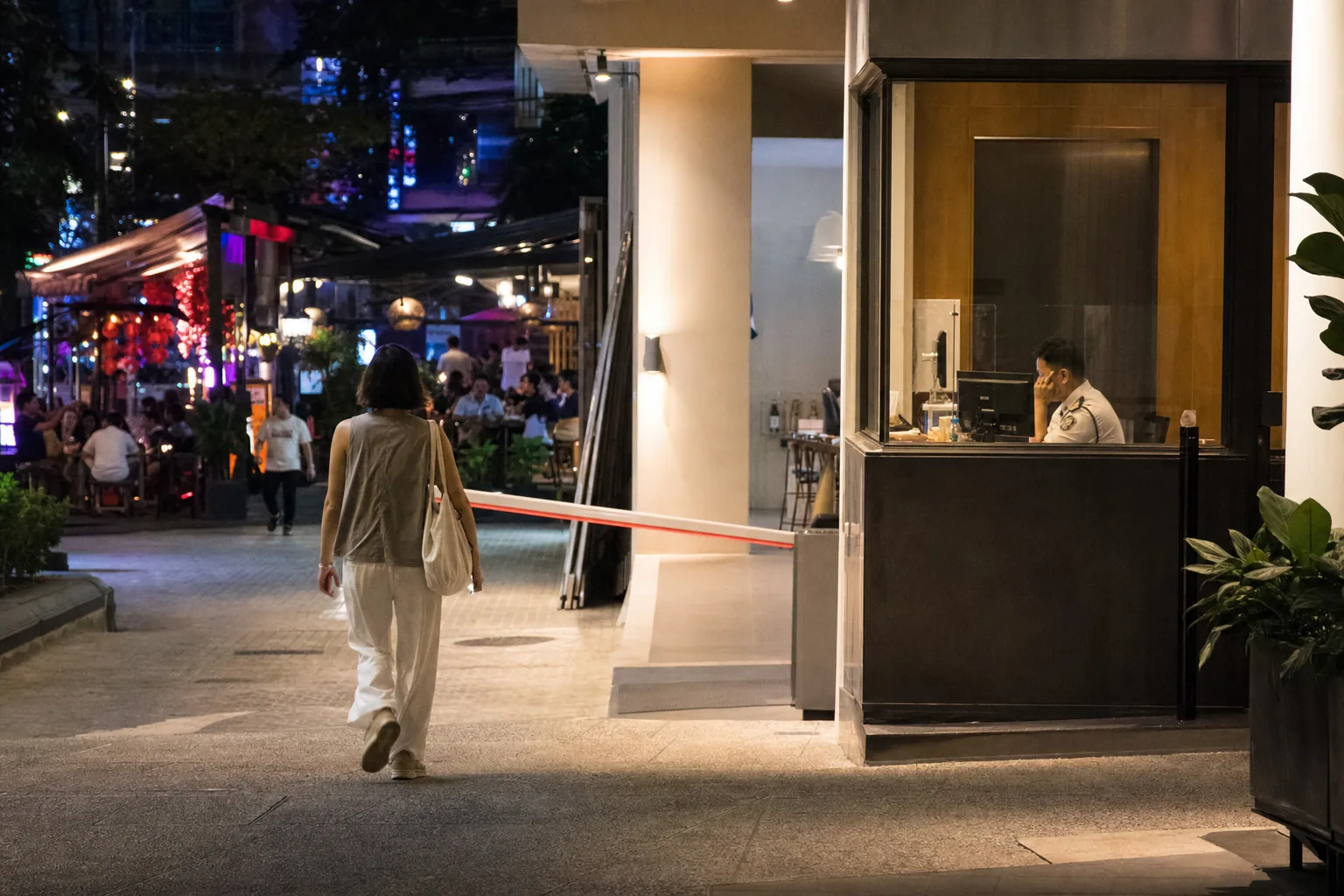 Resident returning to a controlled condominium entrance near Bukit Bintang nightlife