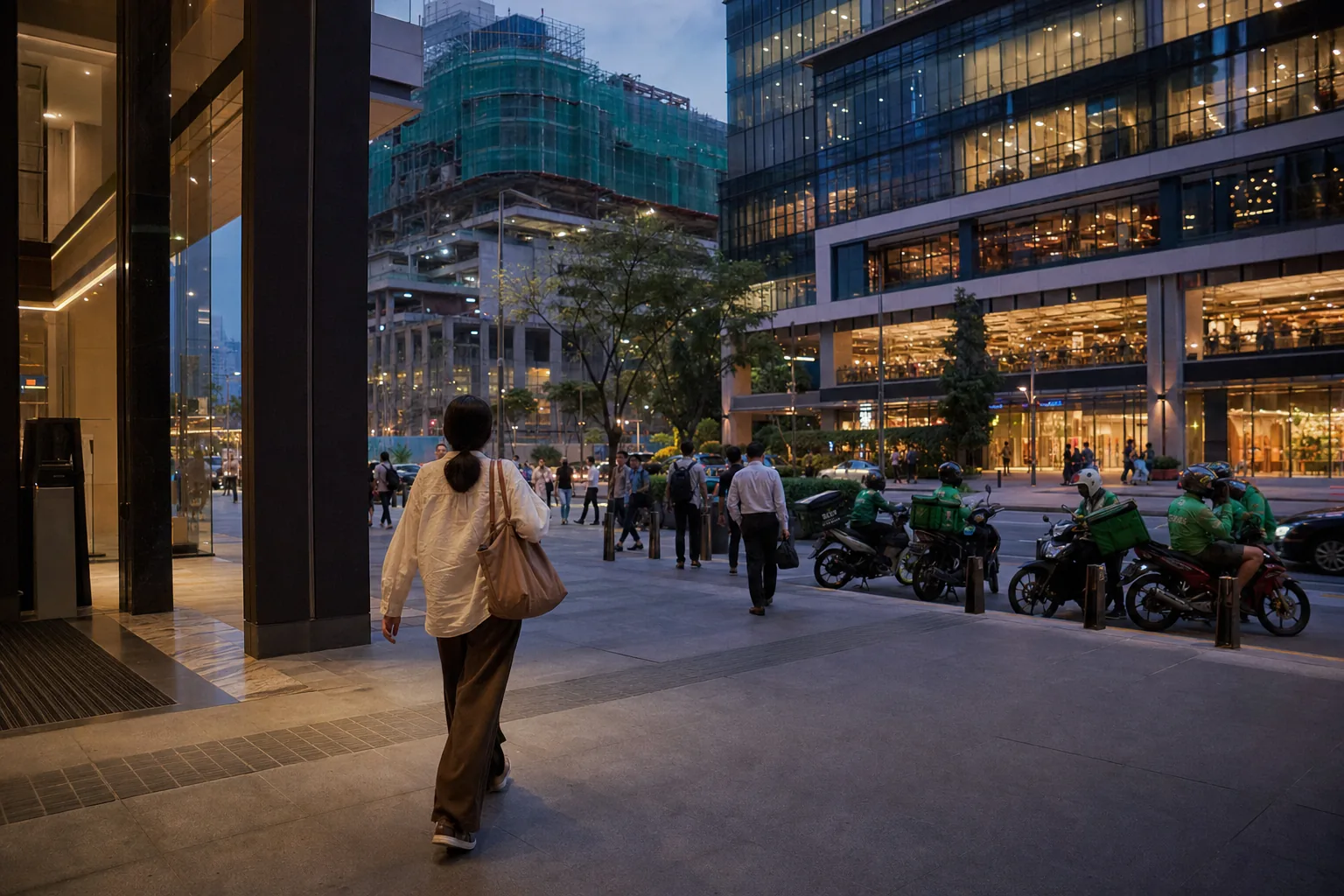Resident leaving a mixed-use TRX-style precinct while nearby construction remains visible