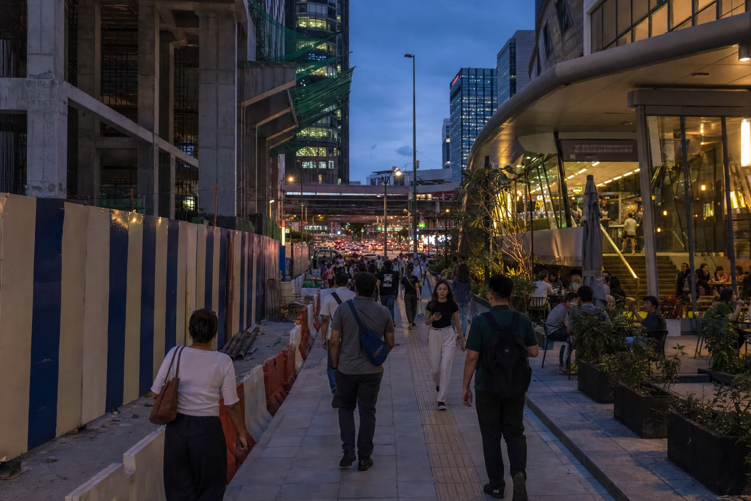 Residents walking beside phased construction and operating city-centre shops near a changing precinct
