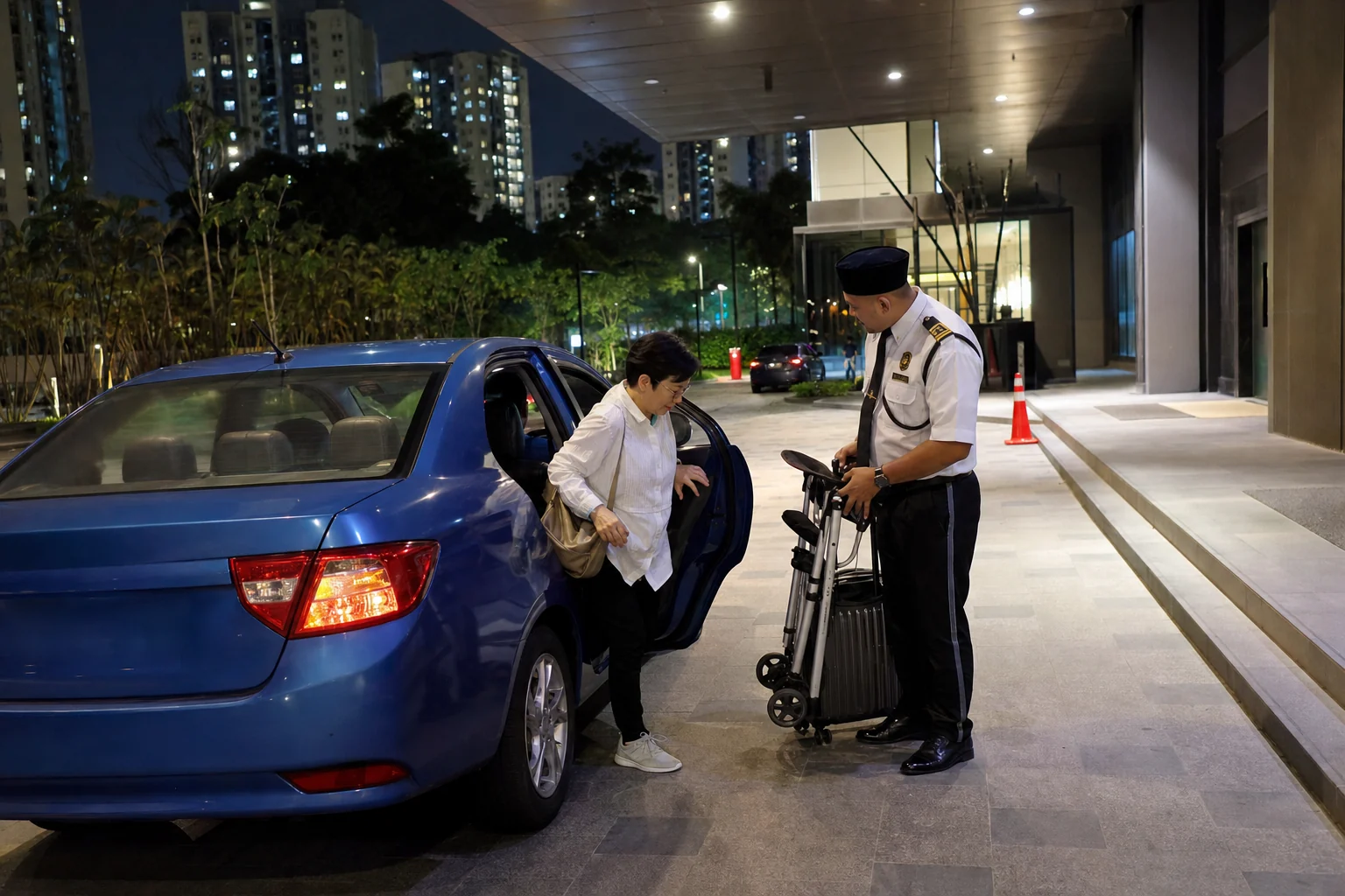 Resident arriving by ride-hailing car at a well-lit Central KL condominium late at night