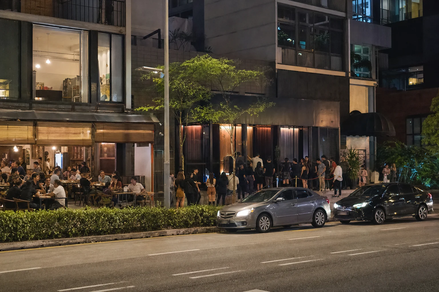 Restaurants, entertainment visitors and ride-hailing traffic on a mixed-use Central KL street at night
