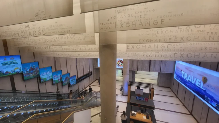 Escalators and signs along The Exchange TRX connection towards the MRT station