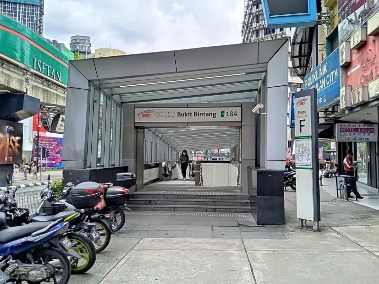 Entrance F at Bukit Bintang MRT station, with steps and escalators below the station sign