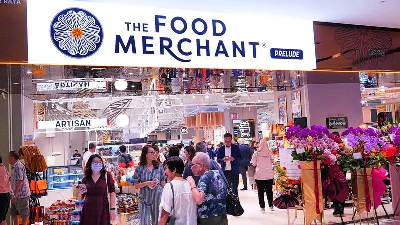 The Food Merchant Prelude entrance with illuminated signage and shoppers inside