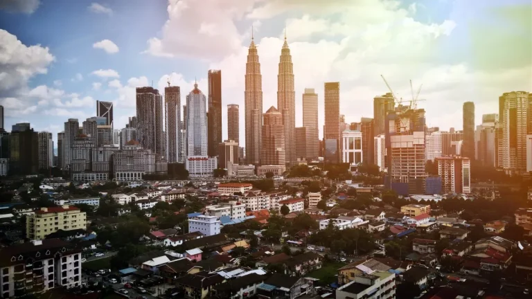 Kuala Lumpur skyline with the Petronas Twin Towers beyond lower buildings and surrounding towers