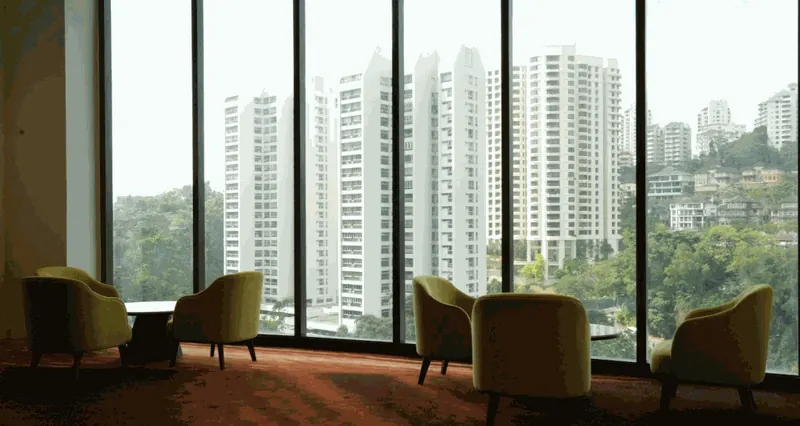 Lounge chairs beside tall windows in the TGV Pavilion Damansara Heights cinema lobby