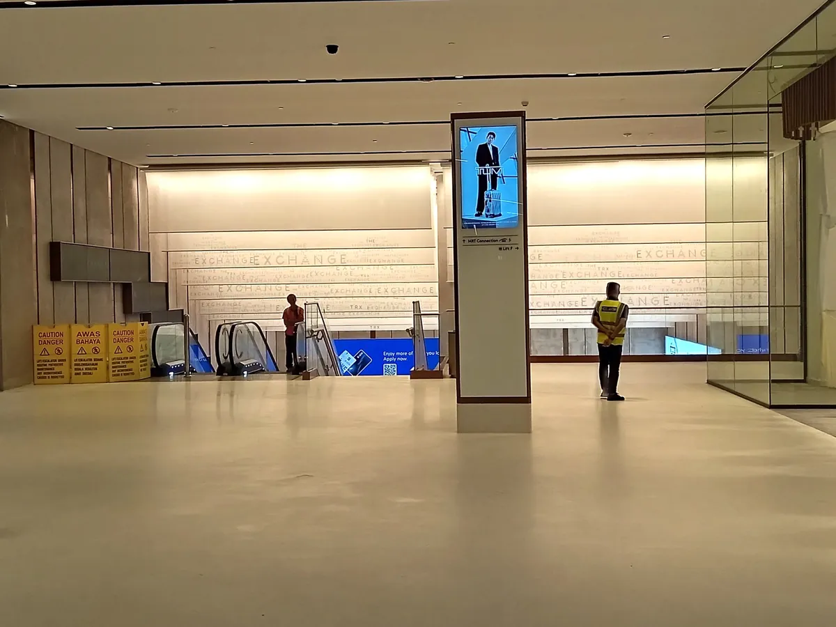 MRT connection sign and escalators inside The Exchange TRX mall link