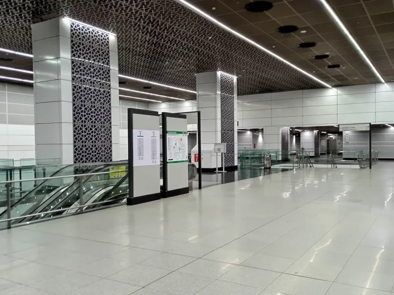 TRX MRT station concourse with escalators, route information and patterned columns